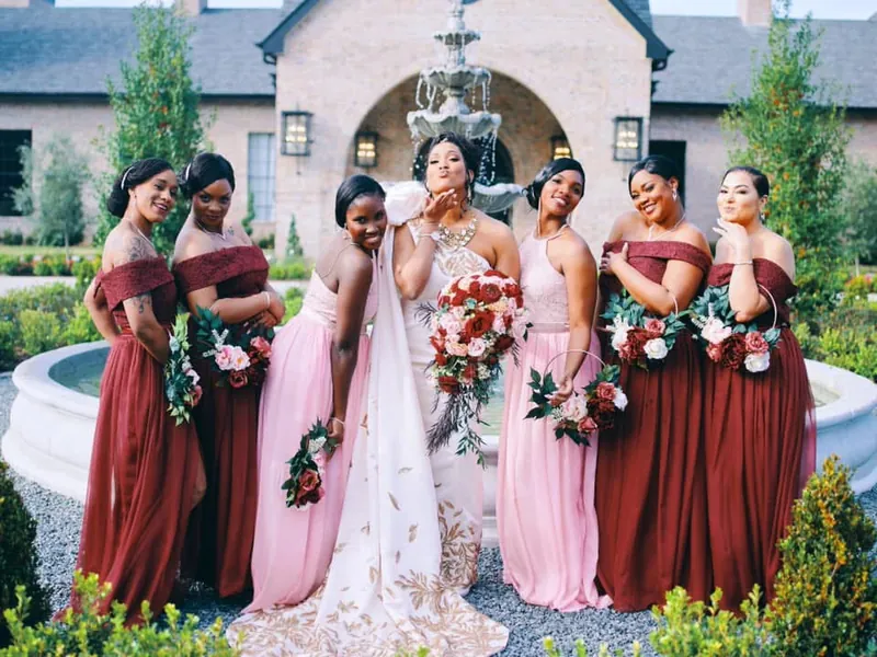 Bride with her bridal party in burgundy and blush gowns