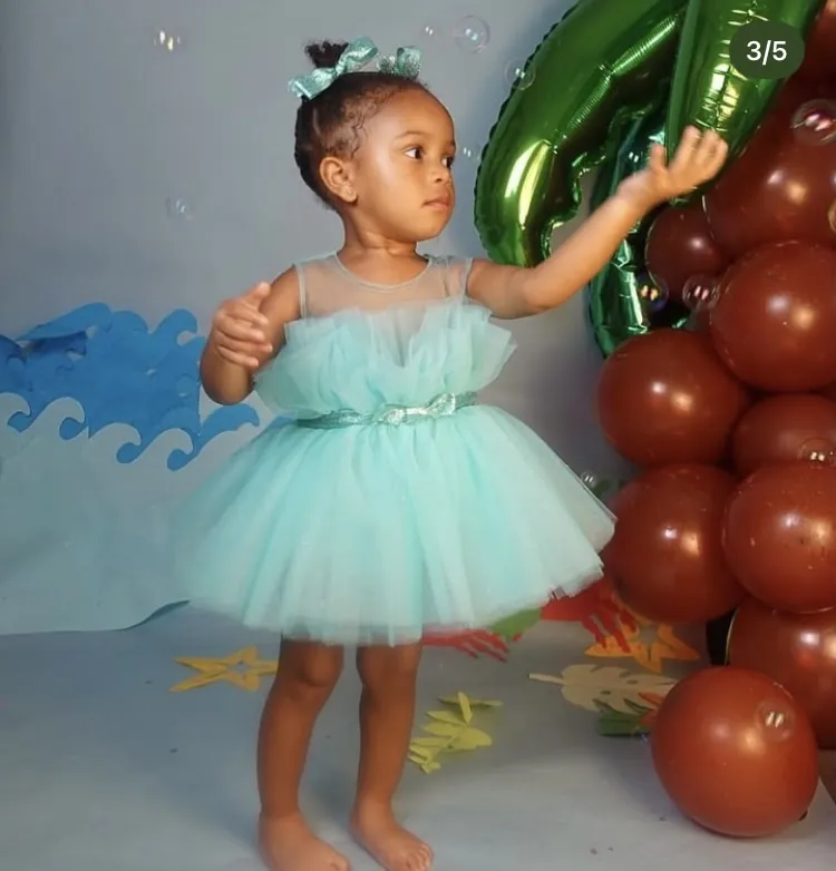 Toddler in a mint tulle party dress