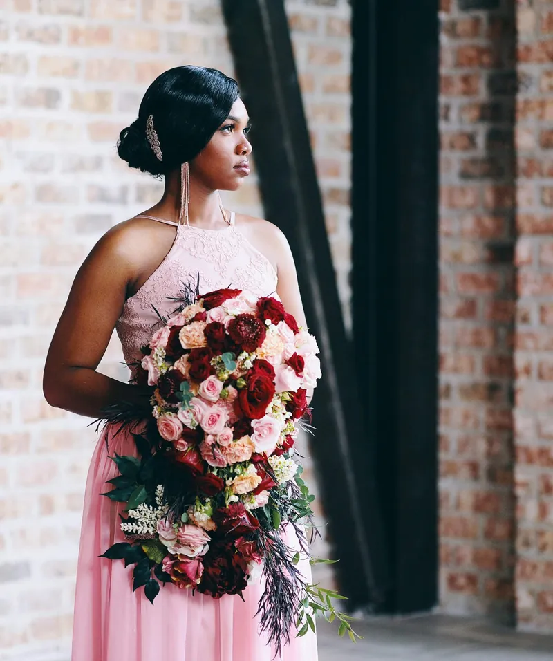 Blush halter gown with a cascading bouquet of roses